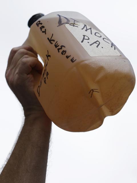 Ray Kemble of Dimock, Pa., protests fracking outside a Marcellus Shale industry conference as he holds a jug of what he said was contaminated well water, on Sept. 20, 2012, in Philadelphia. (AP/Matt Rourke, File)
