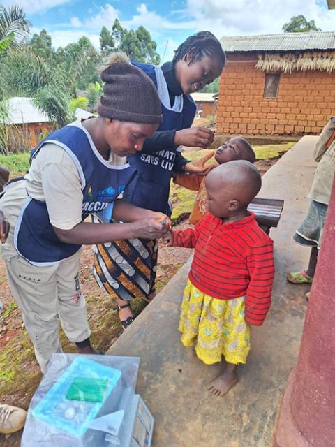 Sr. Veronica Nange Ngeh and her assistant conduct a polio campaign outreach in a neighboring village in a remote area of northwest Cameroon. (Courtesy of Veronica Nange Ngeh) 