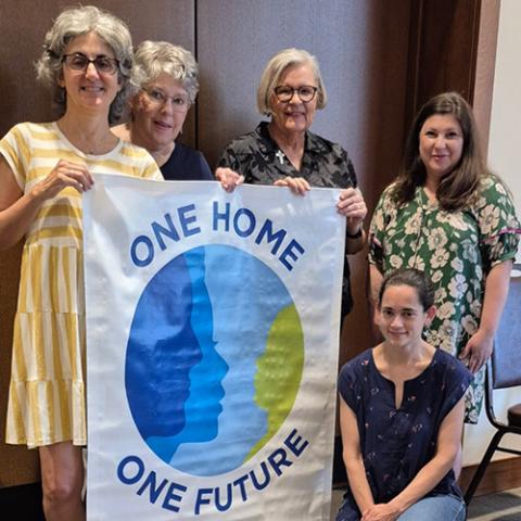 From left: Susan Charrette, Judy Humowiecki, Providence Sr. Sue Paweski, Lauria Kelley and Rebecca Izquierdo display the banner from One Home One Future, a multifaith campaign that energizes communities to work for creation care. (Courtesy of Laura Kelley)