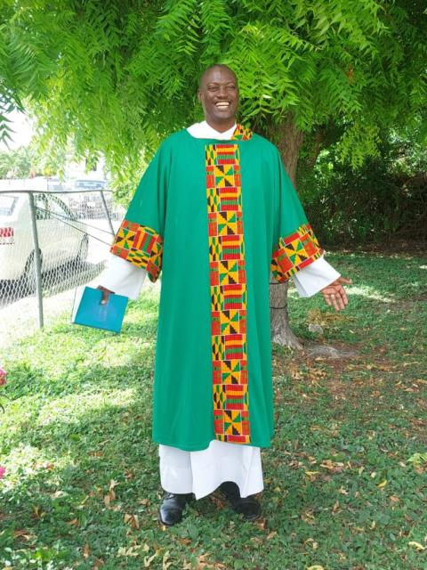 Green vestments with gold, brown, yellow and red accents in a geometric pattern, created by Sr. Jannette Pruitt being worn