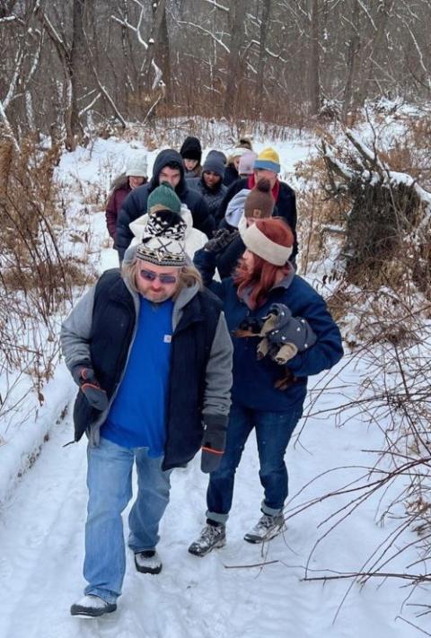 Group of people walking in snow.