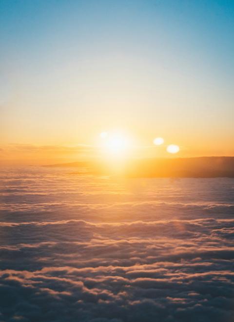 The sun shines amid clouds in a photo of the horizon. (Unsplash/Nic Y-C)