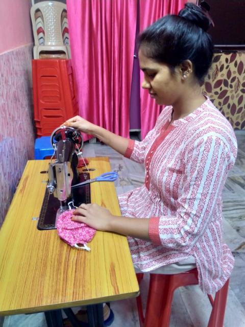 Buli Ranjit, a young kind-hearted girl, stitches masks to share with the needy in her village as Christmas gifts. (Sujata Jena)