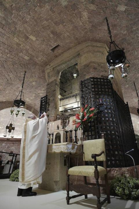 Pope Francis celebrates the Eucharist at the tomb of St. Francis in the crypt of the Basilica of St. Francis in Assisi, Italy, Oct. 3. (CNS/Vatican Media)