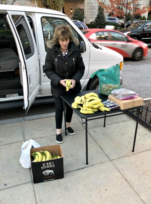 A woman helps set up a fruit and dessert station for the homeless. (Jack McHale) A woman helps set up a fruit and dessert station for the homeless. (Jack McHale)