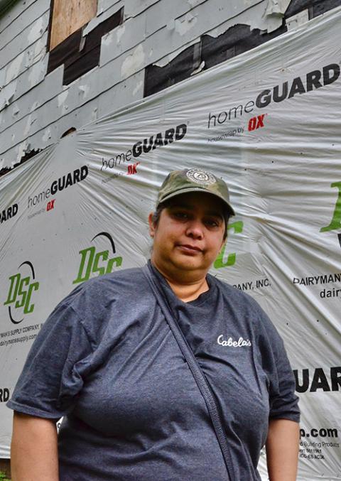 Josepha Casteñeda stands in front of her home May 24 in Mayfield, Kentucky, which was damaged by a milewide EF4 tornado in December. (GSR photo/Dan Stockman)