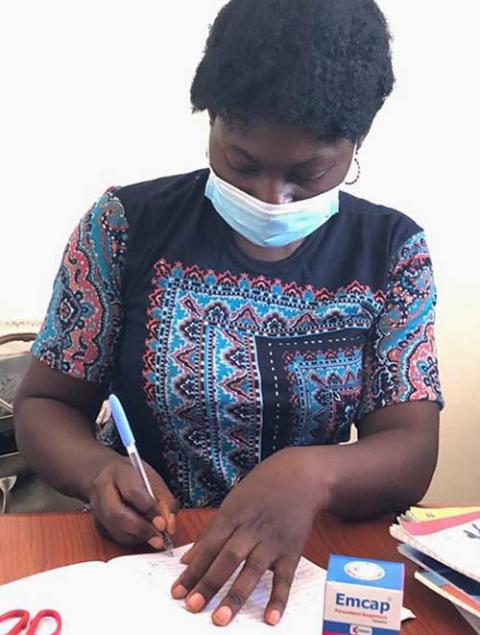 Grace Maikani, a nurse at Area 1 IDP Camp in Abuja, Nigeria, takes notes while on duty. (Chinedu Asadu) Grace Maikani, a nurse at Area 1 IDP Camp in Abuja, Nigeria, takes notes while on duty. (Chinedu Asadu)