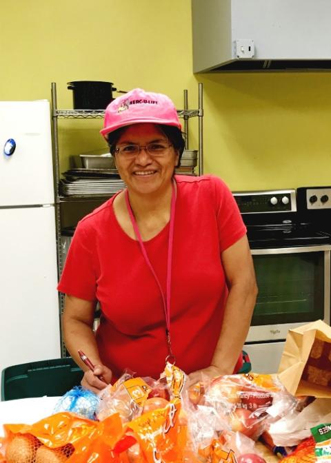 Dubuque Franciscan Sr. Reyna Helen Badillo sorts through food to be delivered in Mississippi. (Courtesy of Sr. Nancy Schreck)