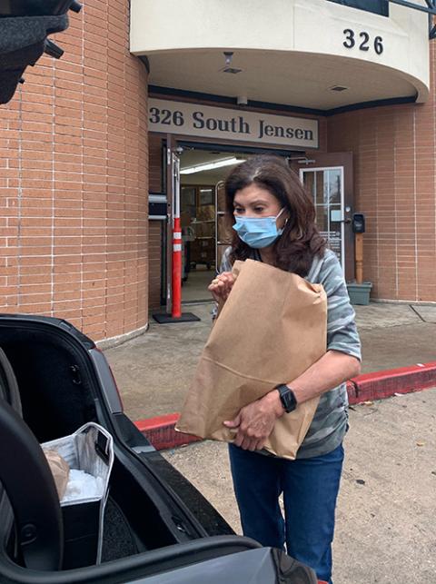 Carol Herrera prepares to load food into a car at Catholic Charity’s Guadalupe Center in East Houston. (Provided photo)