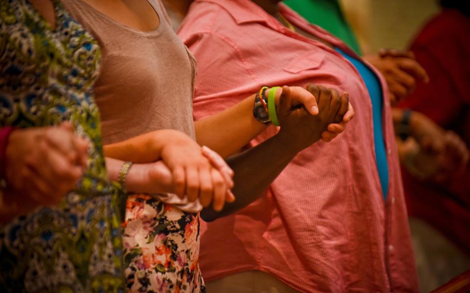 Congregants hold hands and pray during Mass in a 2016 file photo. (CNS/Catholic Herald/Juan C. Medina)