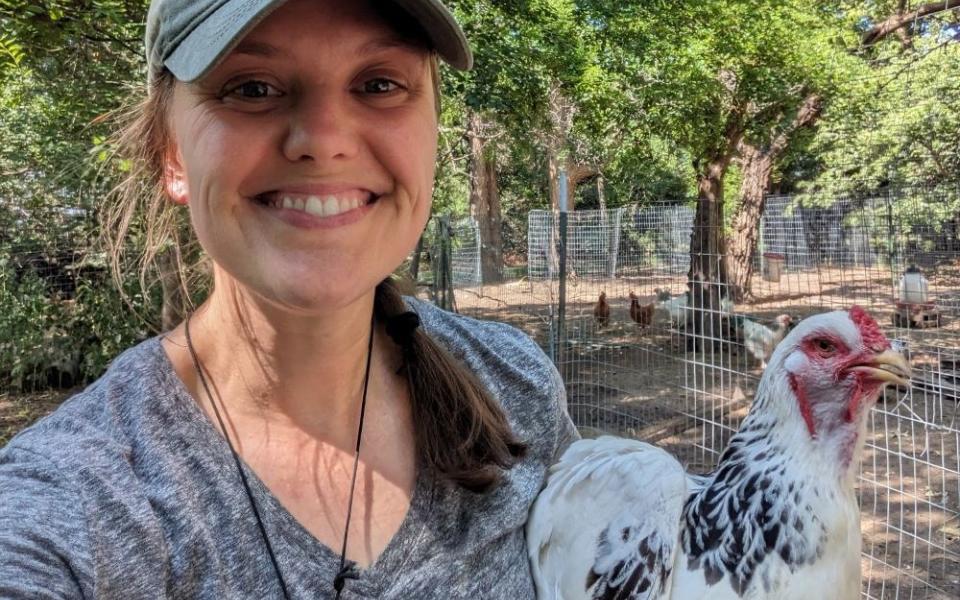 Sr. Terri Schell, a second-year novice of the Dominican Sisters of Peace, poses with a chicken. She is director of the Shepherd's Corner Ecology Center, an ecological ministry the congregation founded in 1992 in Blacklick, Ohio. (Courtesy of Kay Bodmer)