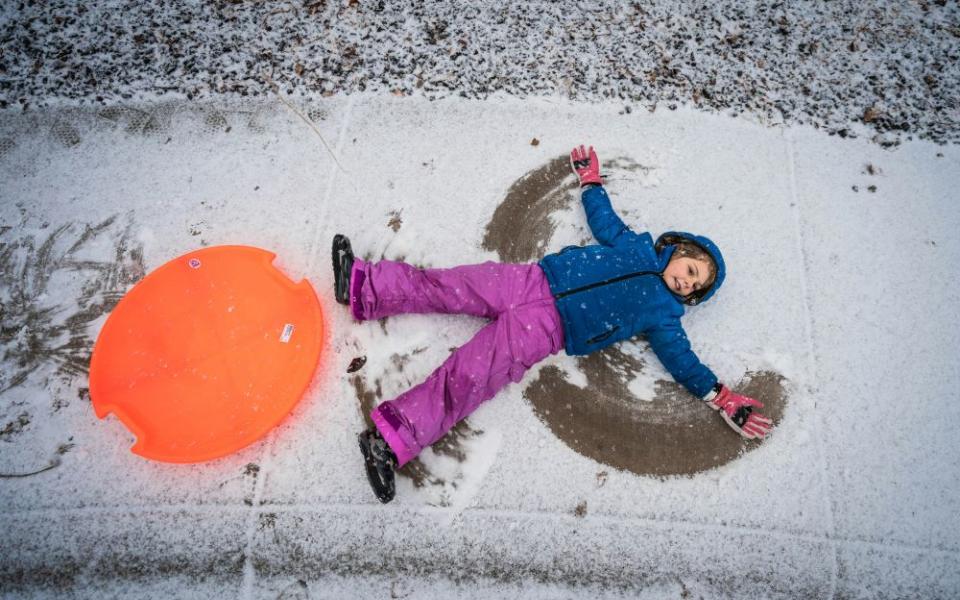 Child makes snow angel