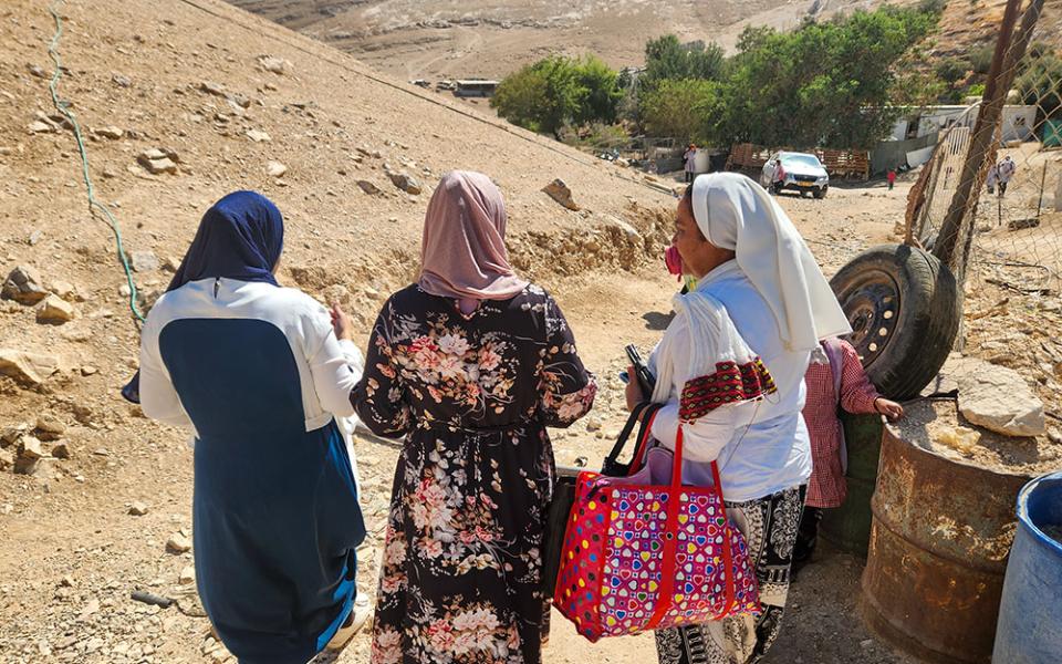 Comboni Sr. Cecilia Sierra, right, with two residents of the West Bank village of Abu-hindi. The Bedouin women did not wish to be identified in photos, worried about the potential harm that could pose to their communities. (GSR photo/Chris Herlinger)