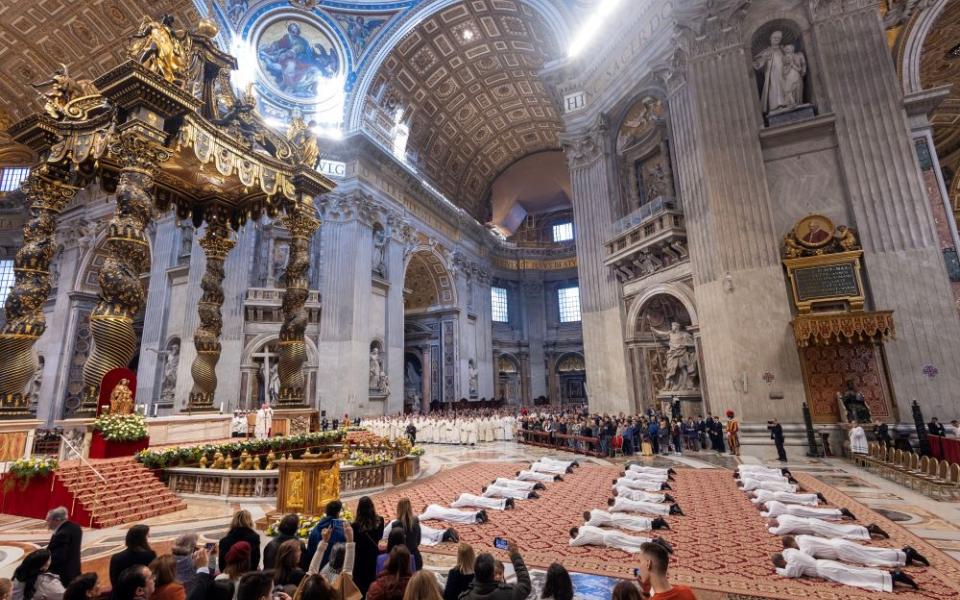 Deacons lie prostrate during ordination Mass in St. Peter's Basilica during the Jubilee of Deacons at the Vatican Feb. 23.