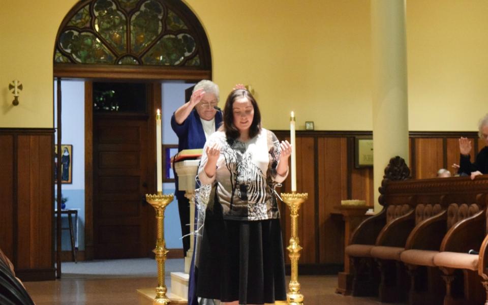 Sr. Esther Fangman, prioress of the Benedictine Sisters of Mount St. Scholastica of Atchison, Kansas, blesses Emily Bauer, 26, as she makes her vows as a canonical novice with the community Dec. 7, 2019.