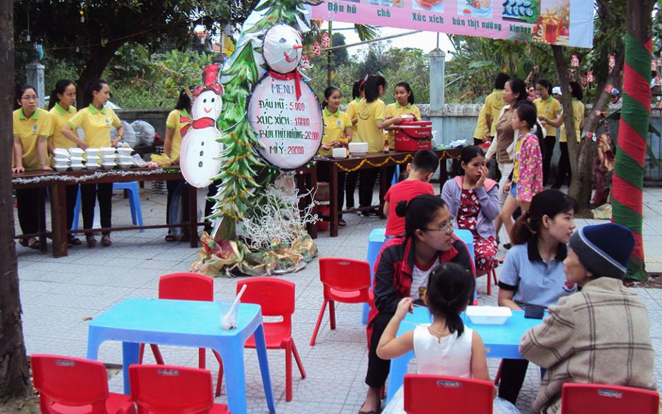 Lovers of the Holy Cross nuns hold a "Christmas market" serving food with budget prices to local people on Dec. 12 at Pho Thach Parish in Phong Dien District of Thua Thien Hue Province, Vietnam. (Peter Nguyen)