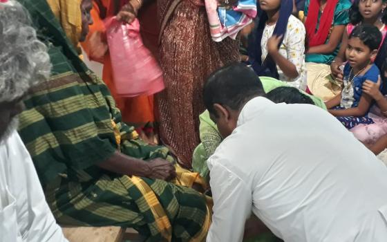 Fr. Anthony Packiam, parish priest of Christ the King church in Madurai in the southern Indian state of Tamil Nadu, washes a woman's feet on Holy Thursday 2022. (Courtesy of Sujata Jena)