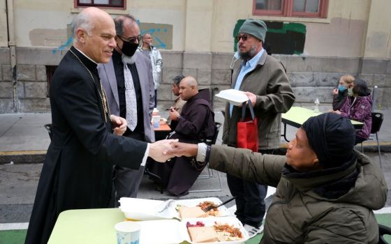 San Francisco Archbishop Salvatore J. Cordileone speaks with patrons during a visit to St. Anthony's Dining Hall in San Francisco's Tenderloin district Nov. 6. Cordileone has revealed he is not vaccinated for COVID-19. (CNS/David Maung)