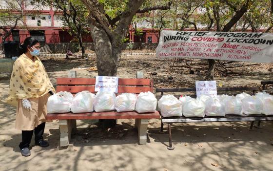 Sr. Rani Punnaserril, a member of the Sisters of the Holy Cross, with food packages for migrant workers (Provided photo)