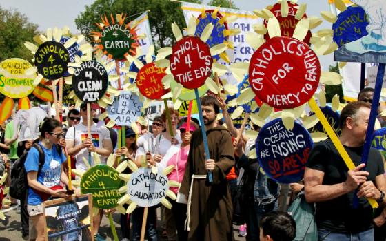 Parishioners from various parishes in New York City hold sunflower signs during the People's Climate March in Washington April 29, 2017. (CNS/Dennis Sadowski)