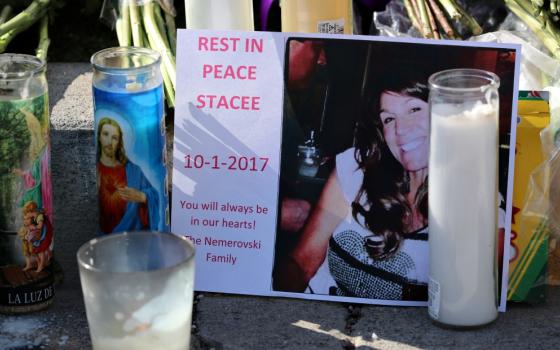 At a makeshift memorial along the Las Vegas Strip Oct. 4, candles surround a photo of one of the victims of the Oct. 1 mass shooting in Las Vegas. (CNS/Reuters/Mike Blake)