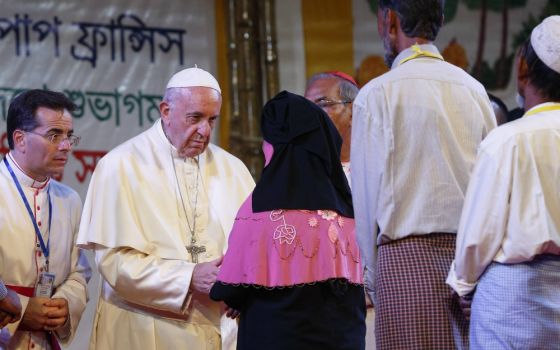 Pope Francis meets Rohingya refugees from Myanmar during an interreligious and ecumenical meeting for peace in the garden of the archbishop's residence in Dhaka, Bangladesh, Dec. 1. (CNS/Paul Haring)