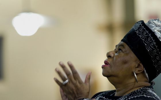 A woman prays on the second evening of an African American Catholic revival celebration Feb. 6, 2018, at St. Rita's Catholic Church in San Diego. (CNS/David Maung)