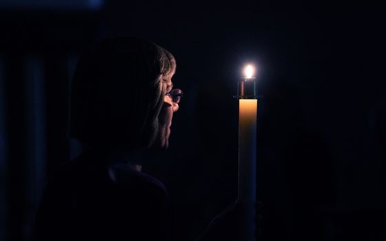 Benedictine Sr. Jennifer Mechtild Horner, prioress of the Sisters of St. Benedict of Beech Grove, Indiana, holds a candle symbolizing the light of Christ during a prayer service at the Our Lady of Grace Monastery Dec. 1, 2018. (CNS/Katie Rutter)