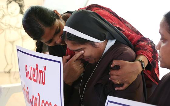 A woman religious is consoled during a Sept. 13, 2018, protest in Cochin, India, demanding justice after a nun accused Bishop Franco Mulakkal of Jalandhar of raping her. (CNS/Reuters/Sivaram V)