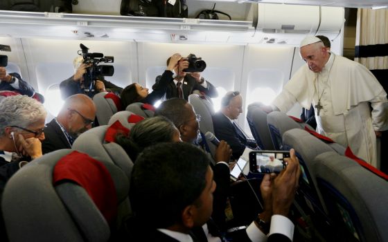 Pope Francis answers questions from journalists aboard his flight from Antananarivo, Madagascar, to Rome Sept. 10. (CNS/Paul Haring)