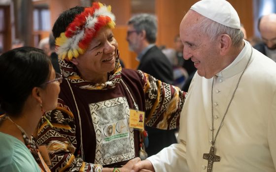 Pope Francis meets Jose Gregorio Díaz Mirabal, coordinator of an umbrella group of Amazonian Indigenous organizations, during a session of the Synod of Bishops for the Amazon at the Vatican in October 2019. (CNS photo/Vatican Media)