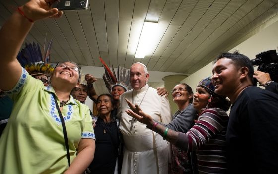 Pope Francis joins in a selfie with Indigenous participants at the Synod of Bishops for the Amazon in October 2019. (CNS photo/Vatican Media) 