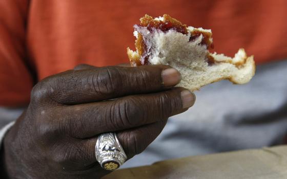 A man eats a sandwich at a soup kitchen in this 2016 file photo. (CNS/Karen Pulfer Focht)