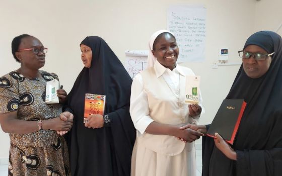 A Catholic woman and nun exchange holy books with Muslim women leaders Dec. 13, 2019, in Garissa, Kenya. (CNS/Courtesy of Fr. Nicholas Mutua)