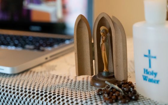 An image of the Blessed Mother adorns a prayer station set up in the home of parishioners of St. Charles Borromeo Catholic Church in Bloomington, Ind., who watched Mass livestreamed from their church March 28, 2020. (CNS photo/Katie Rutter)