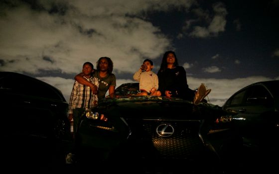 People in Fort Lauderdale, Florida, watch a movie at a drive-in theater during the coronavirus pandemic March 28. (CNS/Reuters/Marco Bello)