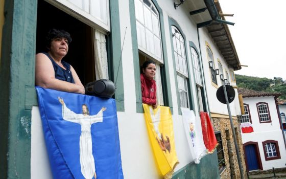 Residents listen to Easter Mass through a local radio station in Ouro Preto, Brazil, April 12, during the COVID-19 pandemic. (CNS/Reuters/Washington Alves)