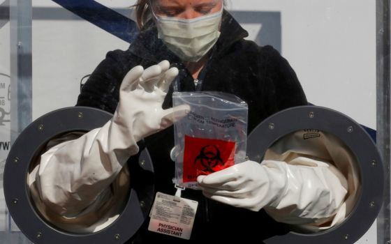 Physician Assistant Cori Kostick demonstrates the Brigham B-PROTECTED testing booth used to administer tests for COVID-19 at the Brigham and Women's Hospital community testing site in Boston May 5. (CNS/Reuters/Brian Snyder)