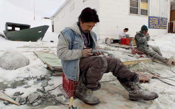 An Inuit carver is pictured in a file photo working on his art on the shore of Frobisher Bay in the Canadian town of Iqaluit, Nunavut. European Catholic leaders warned that Arctic warming is intensifying competition over the region's resources and urged t