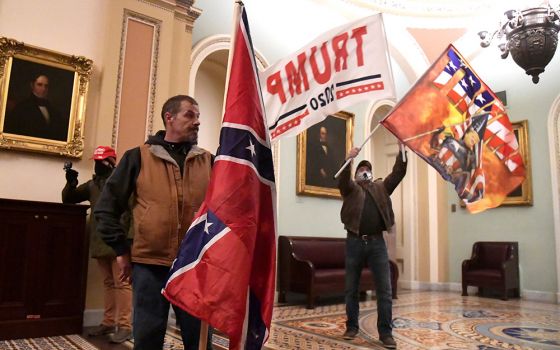 Supporters of President Donald Trump demonstrate on the second floor of the U.S. Capitol building in Washington near the entrance to the Senate after breaching security defenses Jan. 6. (CNS/Reuters/Mike Theiler)