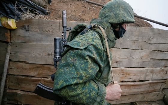 A militant of the separatist Donetsk People's Republic is seen at frontline positions located on the troops contact line with Ukrainian forces near the Ukrainian village of Leninsko Dec. 18, 2020.(CNS photo/Alexander Ermochenko, Reuters)