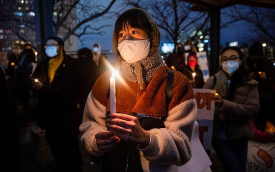 People in Philadelphia attend a vigil in solidarity with the Asian American community March 17. (CNS/Reuters/Rachel Wisniewski)