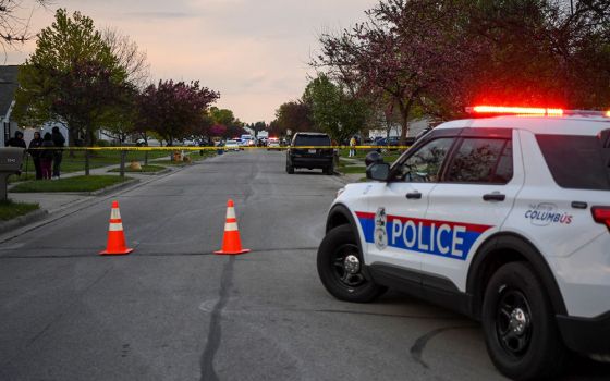 Investigators work at the scene where Ma'Khia Bryant, a 16-year-old Black girl, was fatally shot by a police officer April 20. (CNS/Reuters/Gaelen Morse)