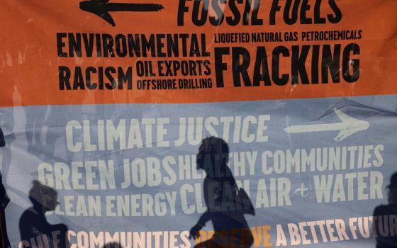 Environmental activists protest outside the White House in Washington, D.C., June 30, demanding that President Joe Biden stop fossil fuel projects and put climate justice at the heart of his infrastructure plans. (CNS photo/Evelyn Hockstein, Reuters)