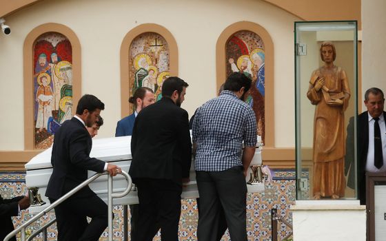 Pallbearers carry the casket of a Guara family member during a funeral Mass at St. Joseph Catholic Church in Miami Beach July 6.