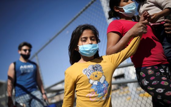 Asylum-seeking migrants from Central America who were deported from the U.S walk near the Lerdo Stanton international border bridge in Ciudad Juarez, Mexico, March 30, 2021. (CNS photo/Edgard Garrido, Reuters)