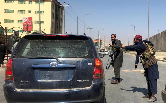 Members of Taliban forces check a vehicle on a street in Kabul, Afghanistan, on Aug. 16. (CNS/Reuters)