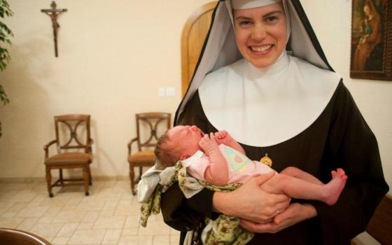 Mother Mary Paschal of the Lamb of God holds her infant niece, Cecelia Potee, in 2011.