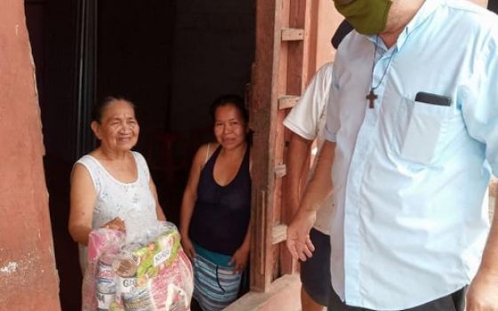 Fr. Raymond Portelli, who has worked in the Peruvian Amazon for nearly three decades, distributes food baskets in Iquitos on Christmas 2020. (CNS/courtesy Fr. Raymond Portelli)