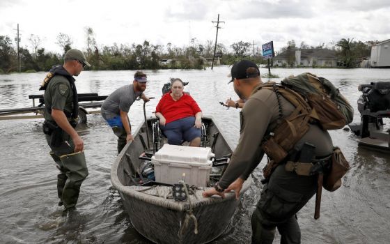 Members of a rescue team in Laplace, Louisiana, help evacuate people Aug. 30, after Hurricane Ida made landfall. (CNS photo/Marco Bello, Reuters)